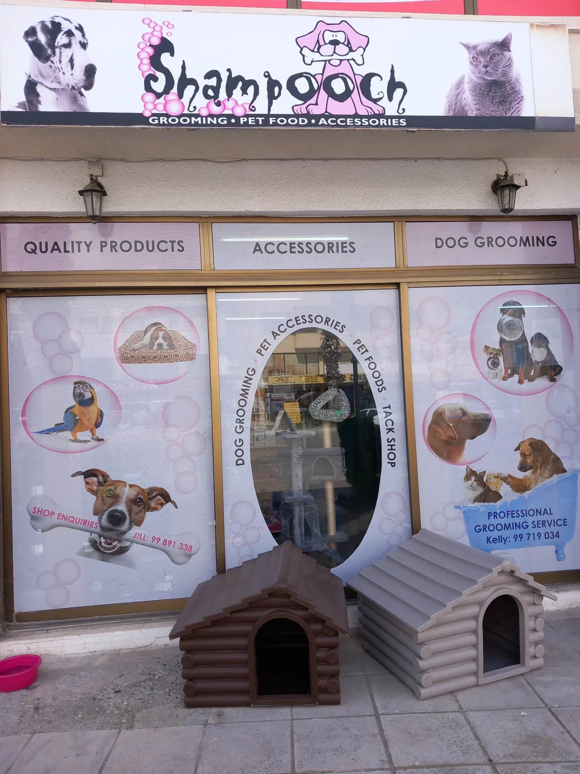 The Shampooch shop front with its pink bubbles sign and two dog kennels outside